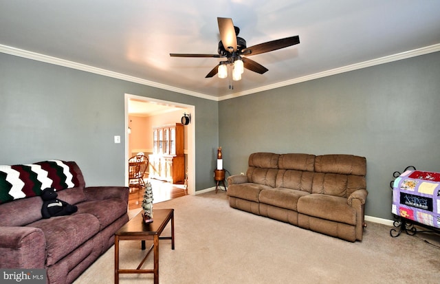 living room with ornamental molding, carpet, and ceiling fan