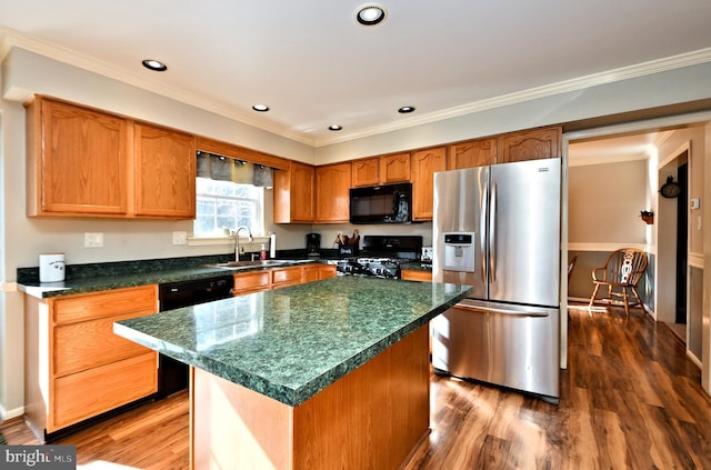 kitchen with sink, dark hardwood / wood-style flooring, a center island, black appliances, and crown molding