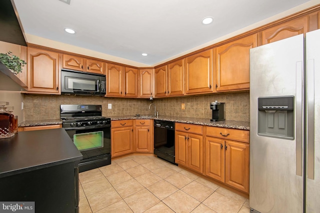 kitchen with sink, decorative backsplash, black appliances, and stone counters