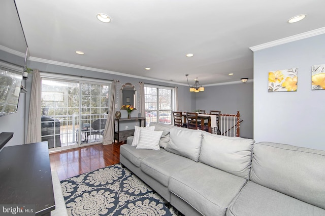 living room with hardwood / wood-style floors and crown molding