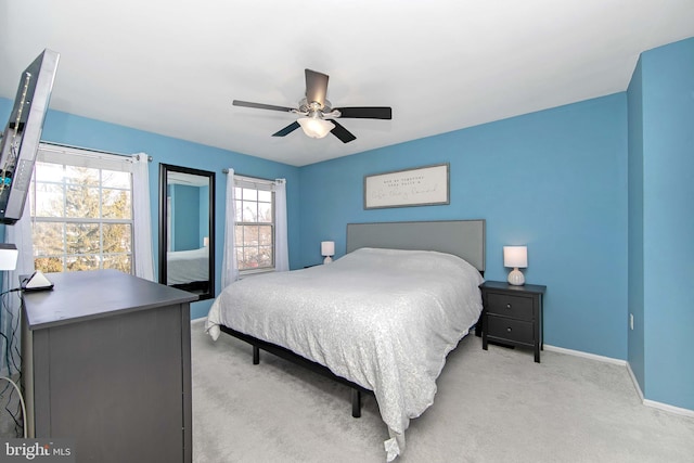 bedroom with ceiling fan and light carpet