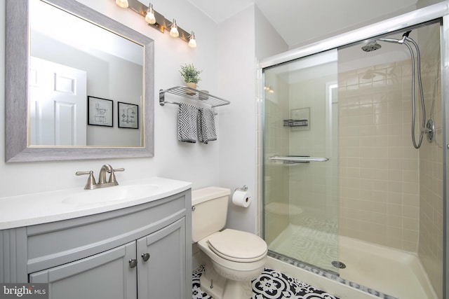 bathroom featuring vanity, toilet, and walk in shower