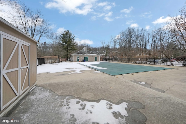 view of swimming pool with an outbuilding and a patio