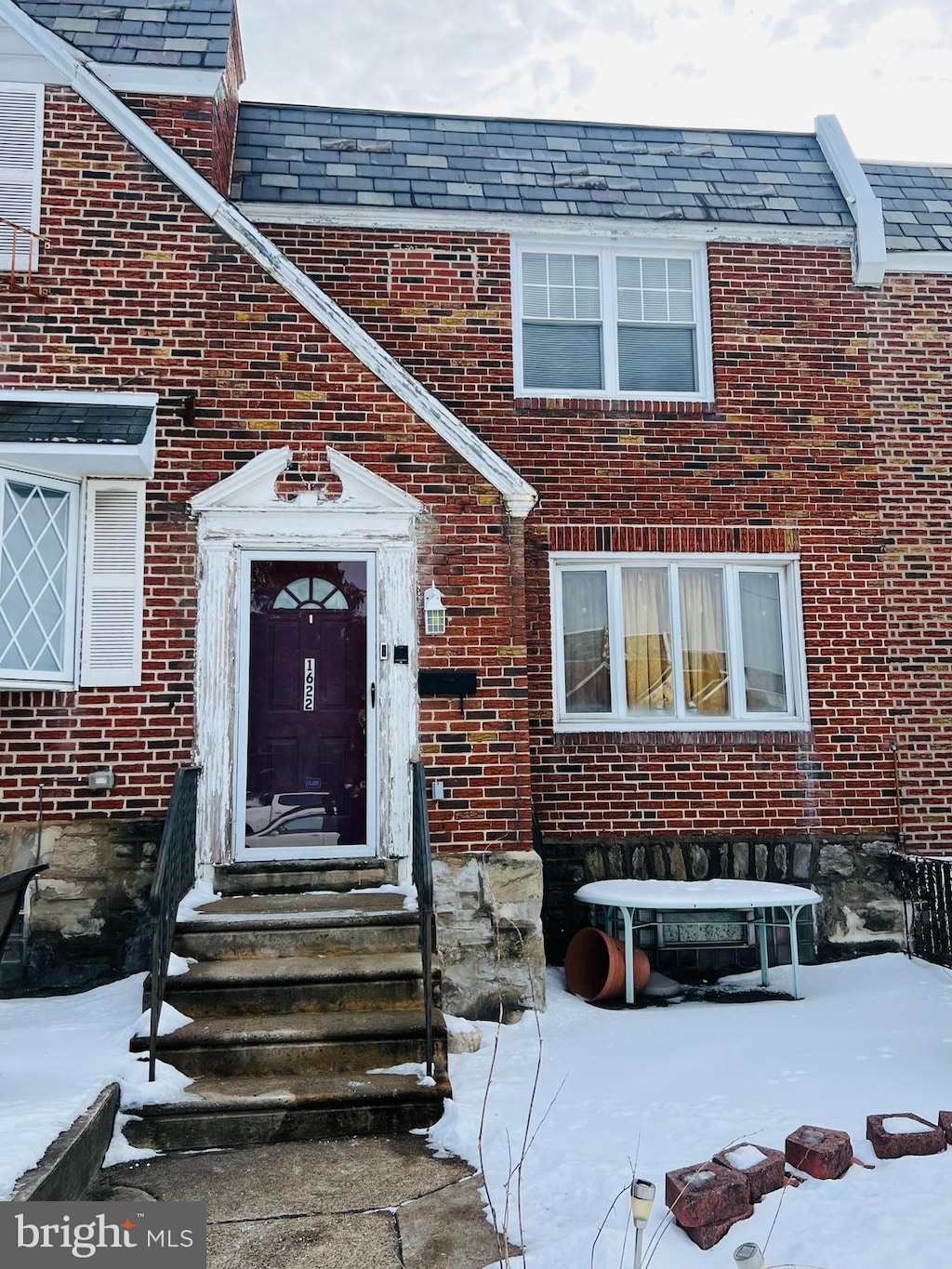 view of snow covered property entrance