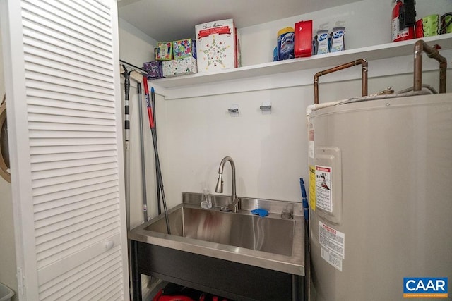 utility room featuring electric water heater and sink