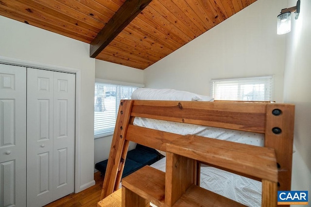 bedroom featuring wood ceiling, wood-type flooring, a closet, and vaulted ceiling with beams