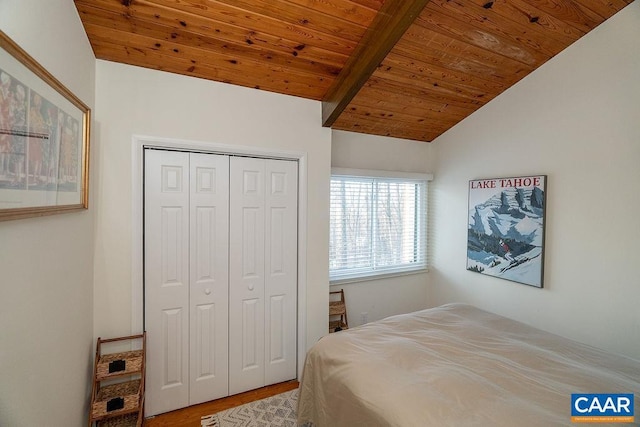 bedroom featuring vaulted ceiling, wood-type flooring, wooden ceiling, and a closet