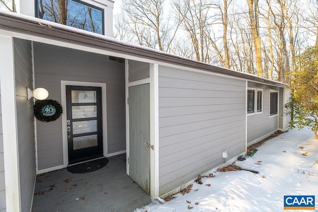 view of snow covered property entrance