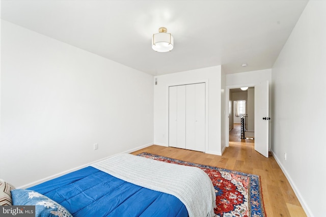 bedroom with wood-type flooring and a closet