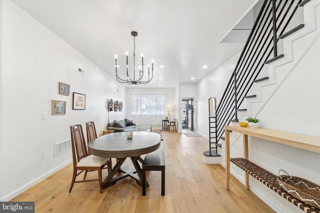 dining room featuring an inviting chandelier and light hardwood / wood-style flooring