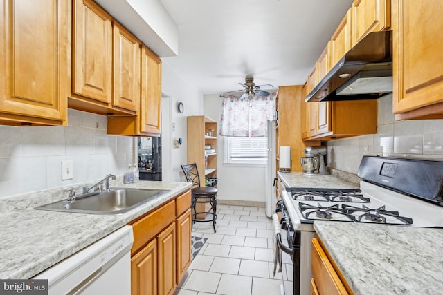 kitchen with range with gas stovetop, tasteful backsplash, dishwasher, sink, and ceiling fan