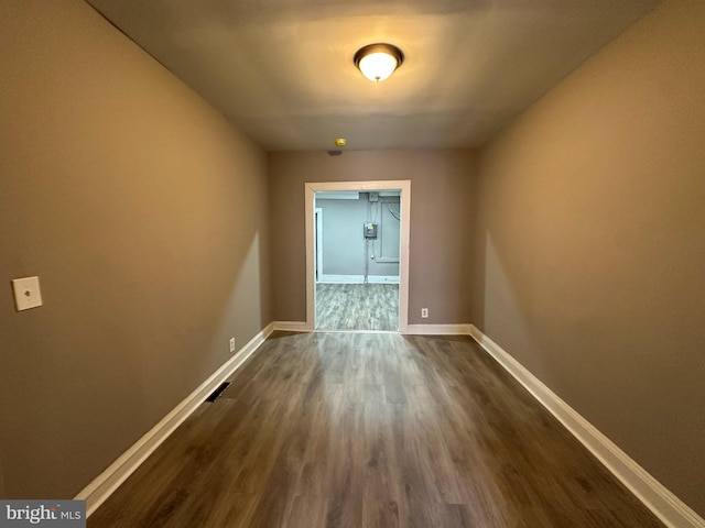 unfurnished room featuring dark hardwood / wood-style flooring