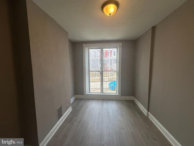 empty room with dark hardwood / wood-style floors