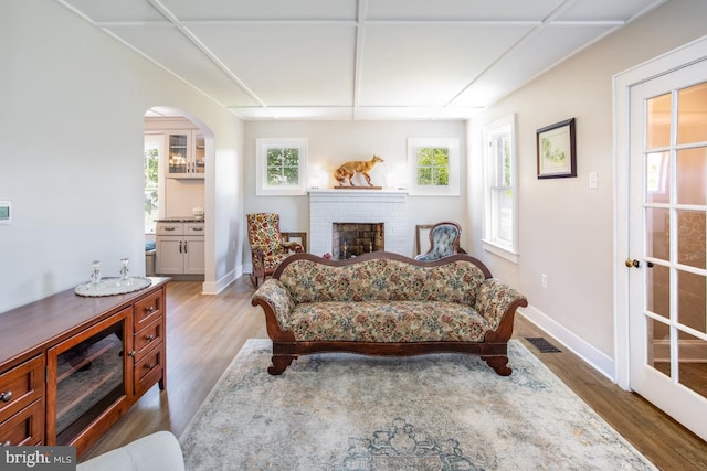 sitting room featuring a brick fireplace and light hardwood / wood-style flooring