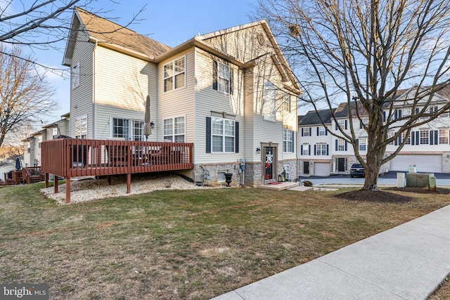 view of property exterior featuring a lawn and a deck