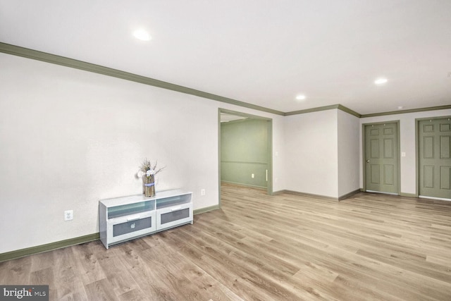 empty room featuring crown molding and light hardwood / wood-style floors