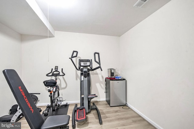 workout room with light hardwood / wood-style floors