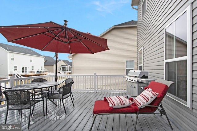 wooden deck featuring a grill