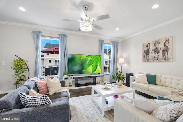 living room featuring ceiling fan, ornamental molding, hardwood / wood-style floors, and a wealth of natural light