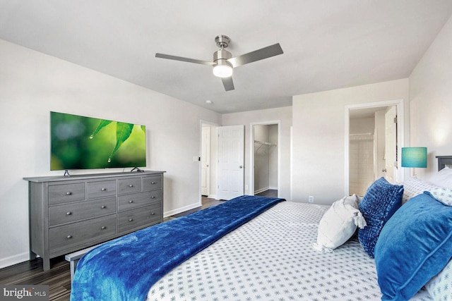 bedroom with ensuite bath, ceiling fan, dark hardwood / wood-style flooring, a spacious closet, and a closet