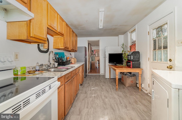 kitchen featuring white electric range oven, washer / clothes dryer, a sink, light countertops, and under cabinet range hood