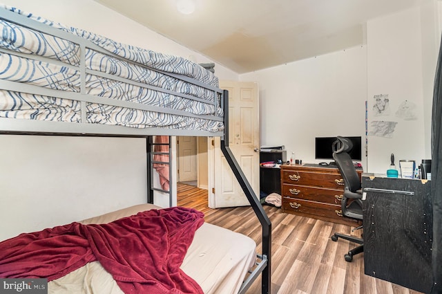 bedroom featuring vaulted ceiling and wood finished floors