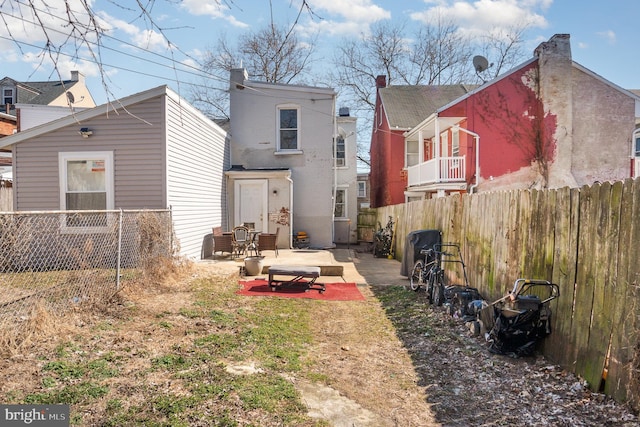 back of property with a patio and fence