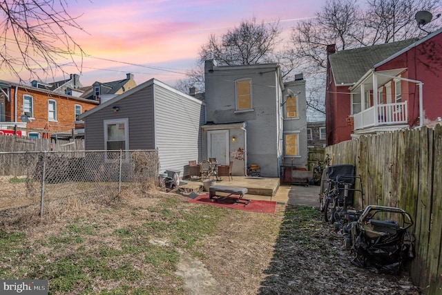 rear view of house with a patio area and fence