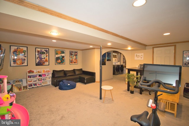 game room featuring ornamental molding, washer / dryer, and carpet flooring