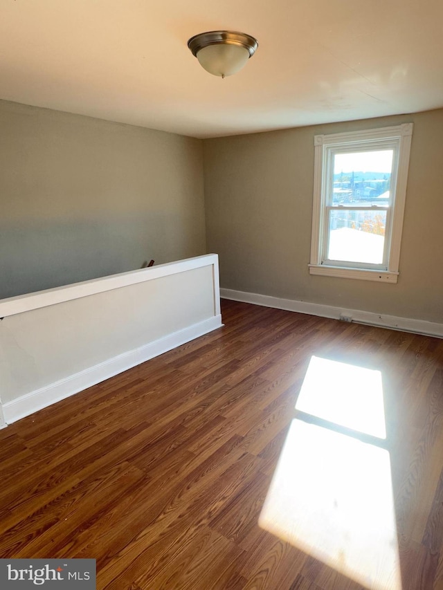 empty room with dark hardwood / wood-style floors