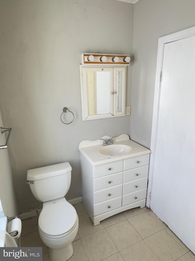 bathroom with vanity, tile patterned floors, and toilet