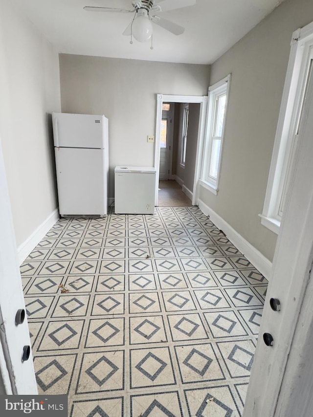 interior space with white refrigerator, ceiling fan, and refrigerator