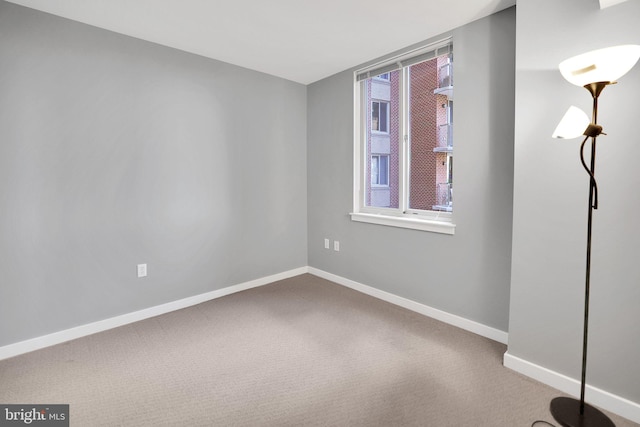 carpeted spare room featuring plenty of natural light