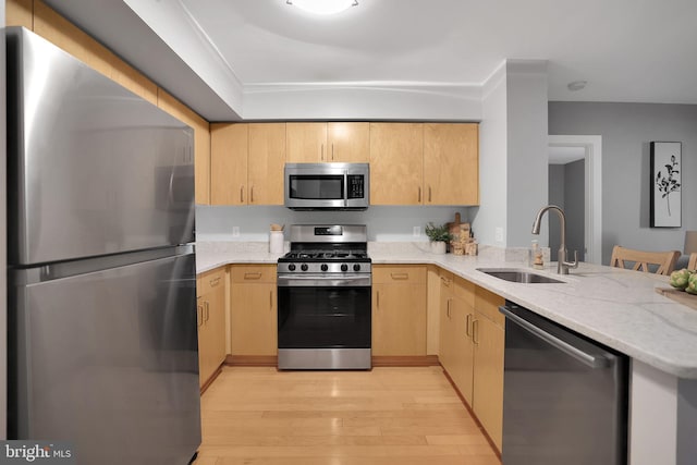 kitchen featuring sink, light brown cabinets, kitchen peninsula, and appliances with stainless steel finishes