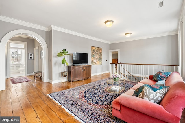 living room featuring crown molding and wood-type flooring