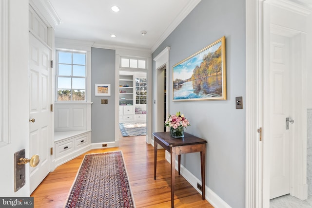 mudroom with ornamental molding and light hardwood / wood-style floors