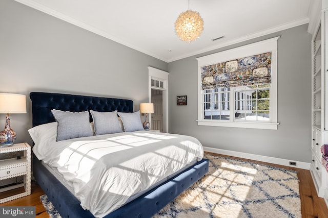 bedroom with dark hardwood / wood-style flooring and crown molding