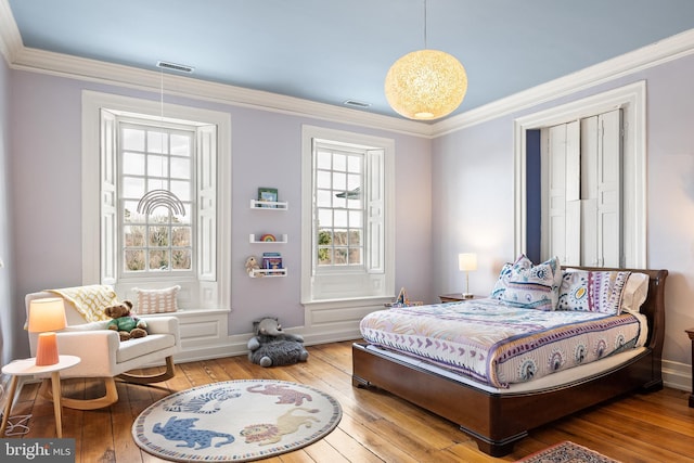 bedroom featuring crown molding and wood-type flooring