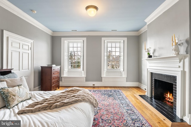 bedroom featuring crown molding and light hardwood / wood-style floors