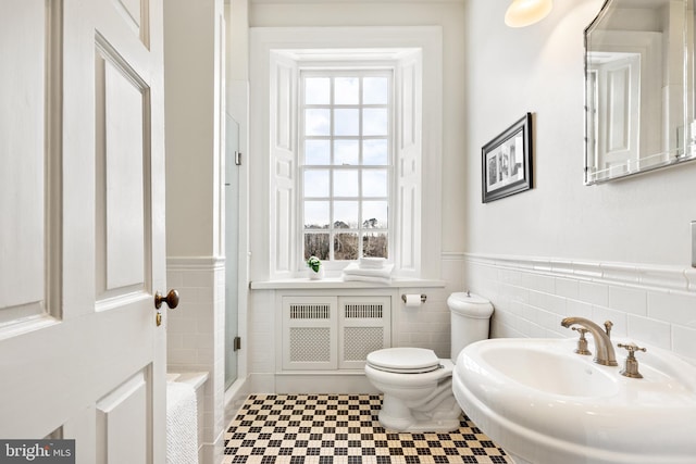 bathroom with sink, tile walls, and a wealth of natural light