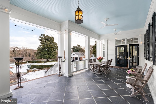 sunroom / solarium with a wealth of natural light, decorative columns, and ceiling fan