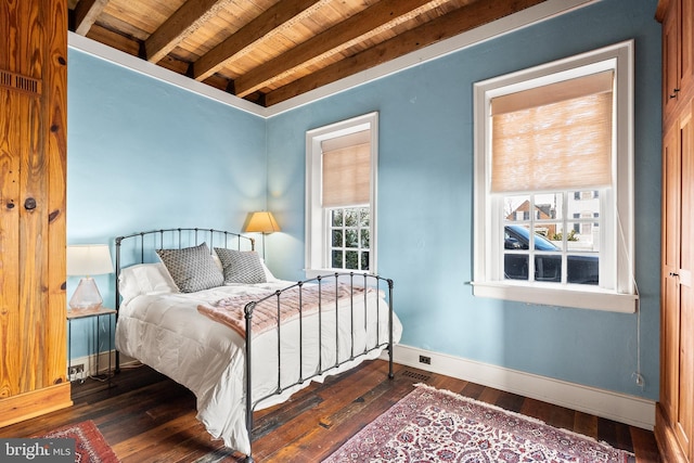 bedroom featuring beamed ceiling, wooden ceiling, and dark hardwood / wood-style flooring