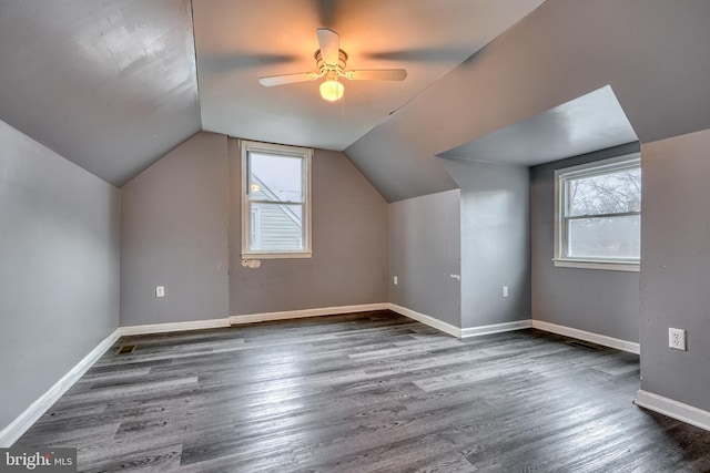 additional living space featuring vaulted ceiling, dark hardwood / wood-style floors, and ceiling fan