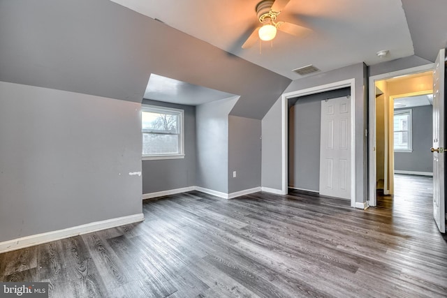 additional living space featuring lofted ceiling, dark wood-type flooring, and ceiling fan