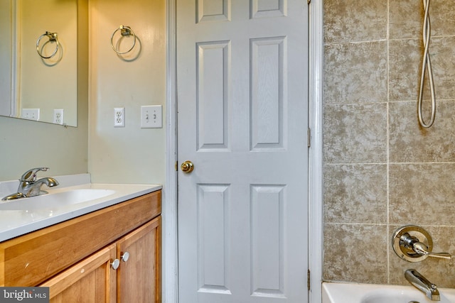 bathroom featuring vanity and tiled shower / bath combo