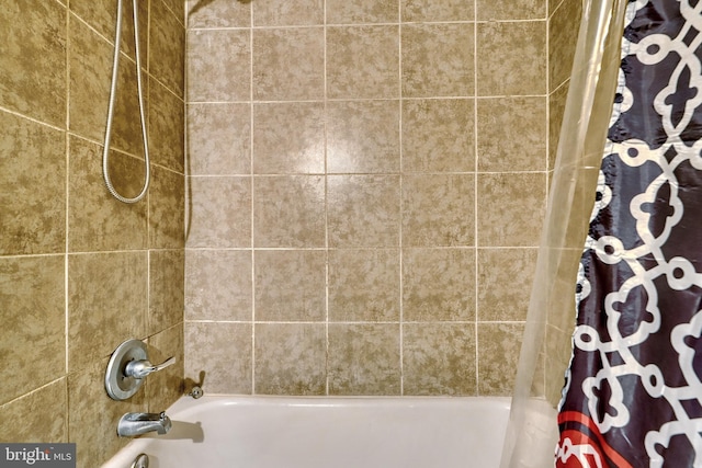 bathroom with shower / bath combo with shower curtain