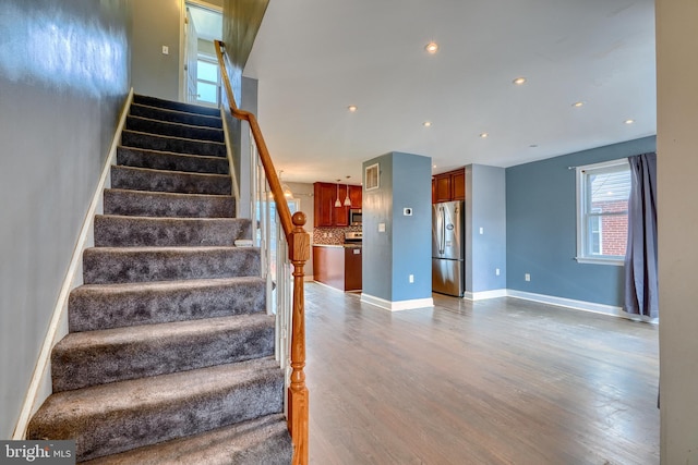 stairs with hardwood / wood-style floors