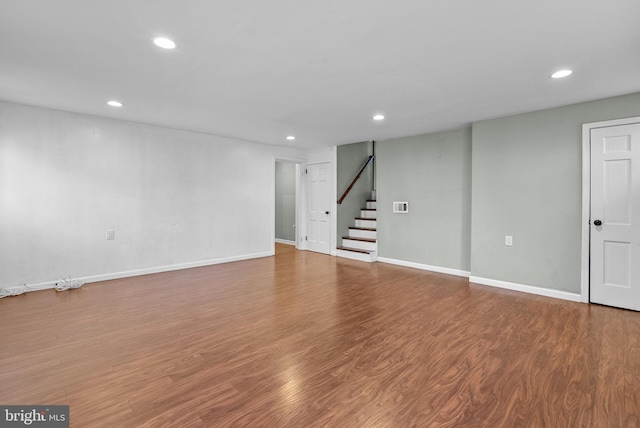 basement with hardwood / wood-style floors