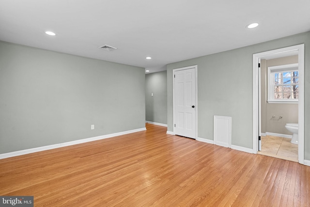 spare room featuring light hardwood / wood-style floors