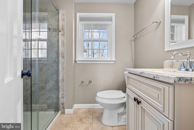 bathroom with vanity, toilet, and a shower with door